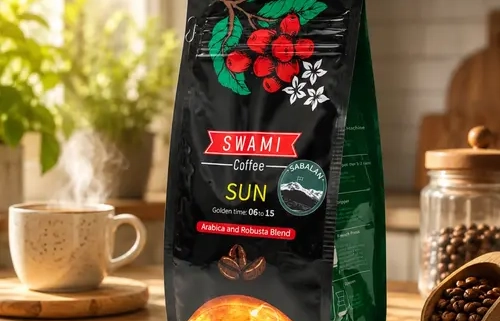 Black SWAMI Coffee packaging for the “SUN” blend (Arabica & Robusta, Golden Time: 06:15), featuring coffee cherries and a sun graphic. Photographed with a steaming cup of coffee, a wooden scoop of beans, and window light.